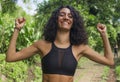 Outdoors portrait of young happy and attractive hispanic woman with curly hair and athletic body gesturing blissful and carefree Royalty Free Stock Photo