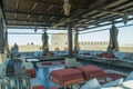 Outdoors restaurant comfortable lounge with tables and pillows on the top of the roof at luxury arabian desert resort