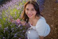 Outdoors romantic portrait of young happy and attractive woman in white summer dress enjoying carefree at beautiful lavender Royalty Free Stock Photo