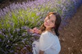 Outdoors romantic portrait of young happy and attractive woman in white summer dress enjoying carefree at beautiful lavender Royalty Free Stock Photo