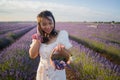 Outdoors romantic portrait of young happy and attractive woman in white summer dress enjoying carefree at beautiful lavender Royalty Free Stock Photo