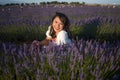 Outdoors romantic portrait of young happy and attractive woman in white summer dress enjoying carefree at beautiful lavender Royalty Free Stock Photo