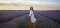 Outdoors romantic portrait of young happy and attractive woman in white summer dress enjoying carefree at beautiful lavender Royalty Free Stock Photo