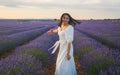 Outdoors romantic portrait of young happy and attractive woman in white summer dress enjoying carefree at beautiful lavender Royalty Free Stock Photo