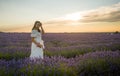 Outdoors romantic portrait of young happy and attractive woman in white summer dress enjoying carefree at beautiful lavender Royalty Free Stock Photo