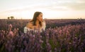 Outdoors romantic portrait of young happy and attractive woman in white summer dress enjoying carefree at beautiful lavender Royalty Free Stock Photo