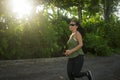 Outdoors running workout - young happy and dedicated Asian Chinese woman jogging at beautiful city park or countryside trail on Royalty Free Stock Photo