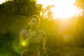 Outdoors running workout - young happy and dedicated Asian Korean woman jogging at beautiful city park or countryside trail on Royalty Free Stock Photo