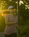 Outdoors running workout - young happy and dedicated Asian Korean woman jogging at beautiful city park or countryside trail on Royalty Free Stock Photo