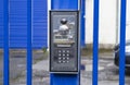 Silver intercom buzzer on a blue gate Royalty Free Stock Photo