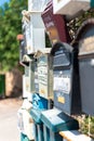 An outdoors shot of a bunch of old mail boxes Royalty Free Stock Photo