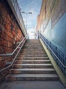 Outdoors staircase behind the buildings walls. Abstract view upstairs, street scene