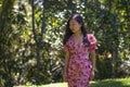 Outdoors Summer lifestyle portrait of young beautiful and happy Asian Chinese woman in elegant dress walking tranquil and cheerful Royalty Free Stock Photo
