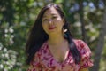 Outdoors Summer lifestyle portrait of young beautiful and happy Asian Chinese woman in elegant dress walking tranquil and cheerful Royalty Free Stock Photo