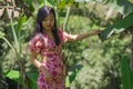 Outdoors Summer lifestyle portrait of young beautiful and happy Asian Korean woman in elegant dress walking tranquil and cheerful Royalty Free Stock Photo