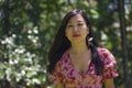 Outdoors Summer lifestyle portrait of young beautiful and happy Asian Korean woman in elegant dress walking tranquil and cheerful Royalty Free Stock Photo