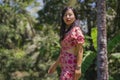 Outdoors Summer lifestyle portrait of young beautiful and happy Asian Korean woman in elegant dress walking tranquil and cheerful Royalty Free Stock Photo