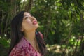 Outdoors Summer lifestyle portrait of young beautiful and happy Asian Korean woman in elegant dress walking tranquil and cheerful Royalty Free Stock Photo