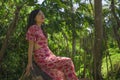 Outdoors Summer lifestyle portrait of young beautiful and happy Asian Korean woman in elegant dress walking tranquil and cheerful Royalty Free Stock Photo