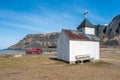 Outdoors at Unstad in Lofoten, Norway. Blue sky, the sea and mountains in the background with red car. Royalty Free Stock Photo