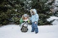 Outdoors winter activities for family. Happy Family, mother, boy kid and dog walking, having fun and drinking hot tea Royalty Free Stock Photo