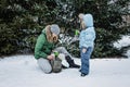 Outdoors winter activities for family. Happy Family, mother, boy kid and dog walking, having fun and drinking hot tea Royalty Free Stock Photo