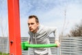 A guy is doing outdoors bar body weight workout Royalty Free Stock Photo