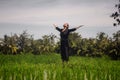 Outdoors yoga and meditation at rice field - attractive and happy middle aged Asian Korean woman enjoying yoga and relaxation in