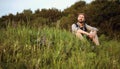 Outdoorsman sitting grass enjoying nature