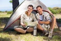 Outdoorsy couple looking at the map outside tent Royalty Free Stock Photo