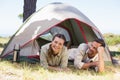 Outdoorsy couple smiling at camera inside their tent Royalty Free Stock Photo