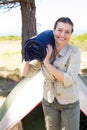 Outdoorsy woman smiling at camera outside her tent