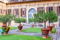 Outer courtyard of the Medici Riccardi Palace, which has an Italian garden with statues and tubs with plants