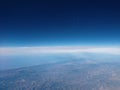 Outer Space to a line of clouds in the atmosphere with the mountains of California beneath