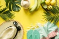 Outfit beach female accessories. Straw sunhat, coconut drink on yellow. Tropical vacations. Top view. Copy space Royalty Free Stock Photo