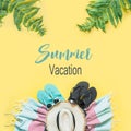 Outfit for beach and tropical vacations, straw hat, towel, sun glasses on yellow. Summer concept Royalty Free Stock Photo