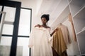 Curly fashionable woman choosing outfit for day Royalty Free Stock Photo