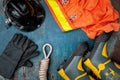 Outfit of Firefighter placed on old table background.