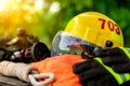 Outfit of Firefighter placed on wooden table and nature background.