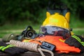 Outfit of Firefighter placed on wooden table and nature background.