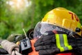 Outfit of Firefighter placed on wooden table and nature background.