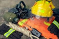 Outfit of Firefighter placed on wooden table and nature background.