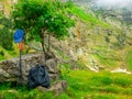 Outfit hiker. Backpacks, walking sticks and a tourist`s cap in the mountains on a halt under a tree