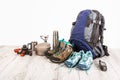 Outfit of traveler, climber, student, teenager. Overhead of essentials for modern sport young person. Different objects on wooden