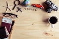 Outfit of traveler with cup of coffee on wooden background