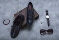 Outfit for a wealthy woman consisting of: monkstrap leather shoes, sunglasses, white gold ring, red bracelet and dress watch Royalty Free Stock Photo