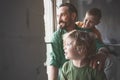 Cheerful parent and sons watching at street