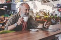 Outgoing pensioner tasting mug of beverage