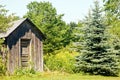 Outhouse on edge of woods