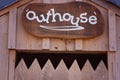 An Outhouse Sign Above A Jagged Door Royalty Free Stock Photo